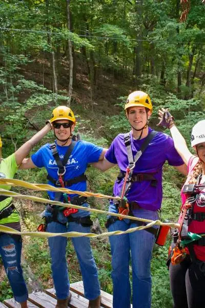 Four people standing on a high platform at Shawnee Zipline