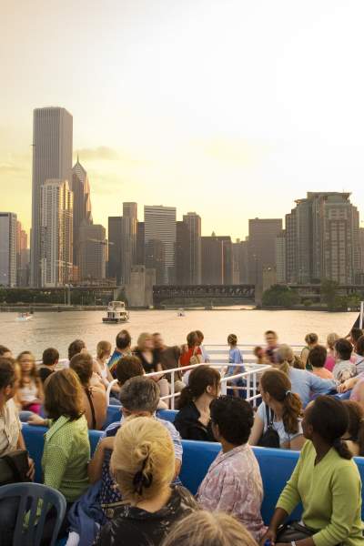 Group of people on a boat tour on Lake Michigan with Chicago in the background